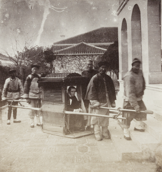 Richard Newby in a sedan chair by the Mercantile Bank, Shanghai