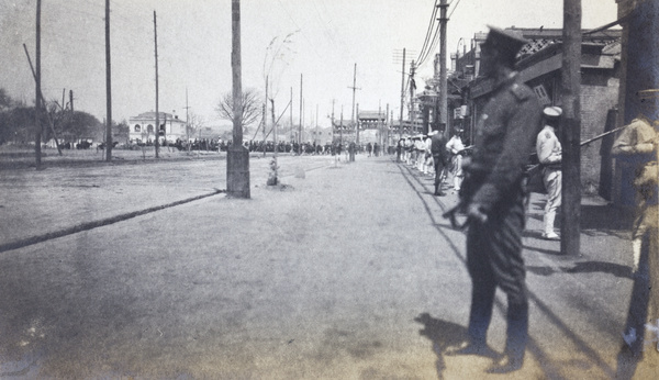 Qing soldiers and a policeman guarding a road