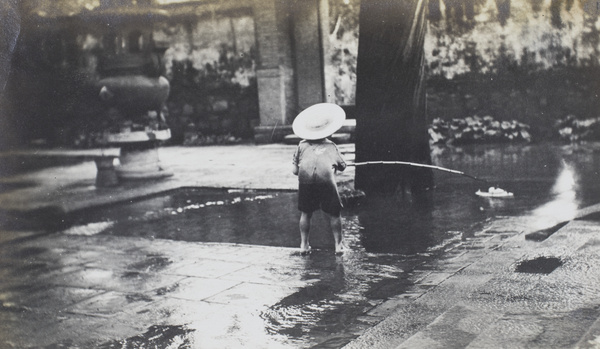 Brian Boyd Cooper playing with a boat