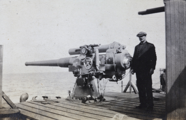 Man with a gun mounted on a ship