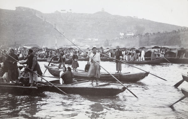 Sampans and sampan men, by a walled city