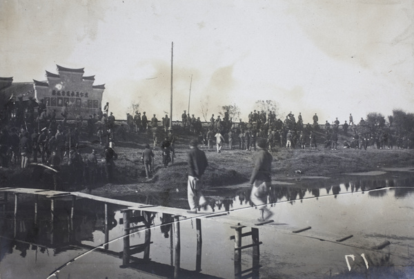 Revolutionary soldiers and onlookers watching the fighting from a railway embankment near Kilometre Ten