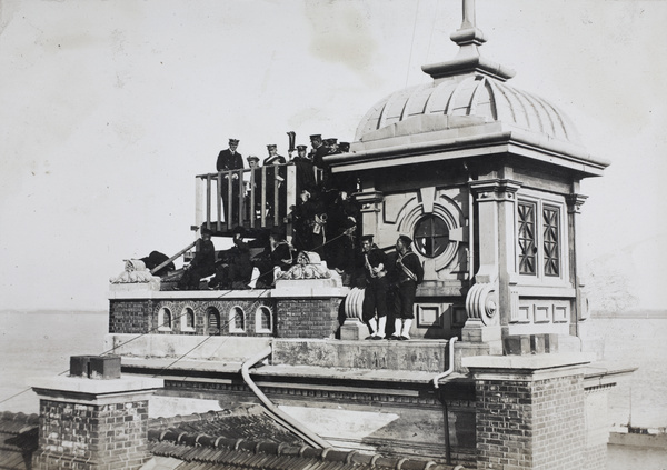 British and Japanese naval officers watching fighting from the roof of the Japanese Consulate, Hankow