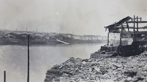 Ruins and wrecked boats, riverside Hankow after the fire