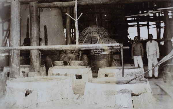 Workers by gas-fired brine evaporating pans, salt wells, Tzuliuching, Zidong
