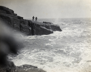 Two men on a rocky outcrop