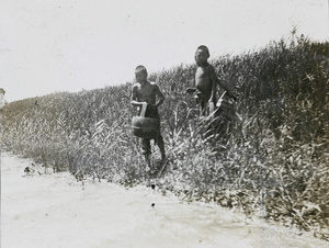 Children with baskets on a riverbank