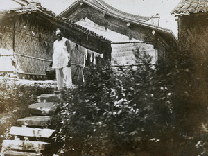 Man with buildings made of reeds