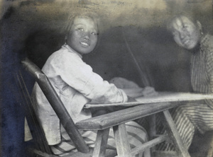 Two women sitting by a trestle