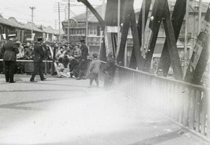 Police searching belongings on a bridge, Shanghai