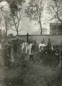 Funeral procession with boys in uniform