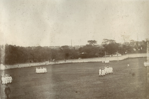 Groups of cadets marching on a sports field