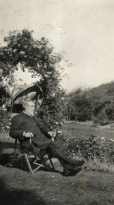 Bishop Banister in a garden chair