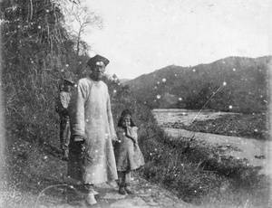 Man and child on riverside path