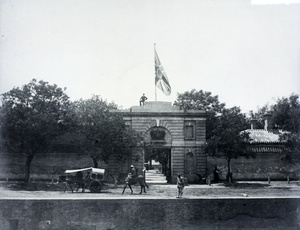 Man and flag on entrance to the British Legation, Peking