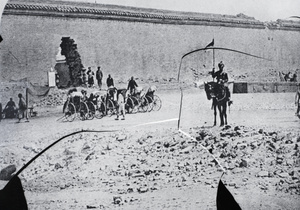 Breach in a city wall, with rickshaws and Sikh trooper, Beijing