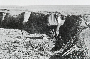 A photographer taking a photograph in military earthworks