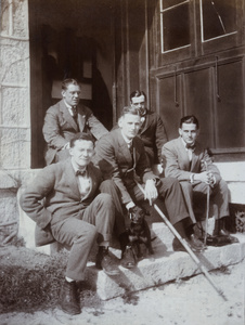 Group of men on a doorstep