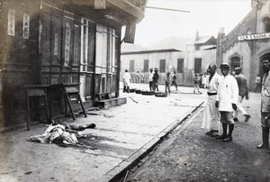 Covered corpse on a pavement, Hankow