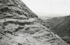 Porters on mountain road near Chaotung