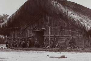 Aborigines sitting in front of house, Tsui-sia, Taiwan