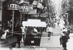 A sedan chair crossing Wellington Street, Hong Kong