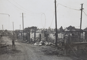 Soldier in street of war damaged buildings, Zhabei, Shanghai, 1932