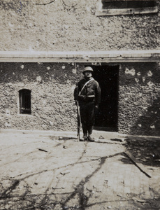 Japanese soldier posing in bomb damaged area, Shanghai, 1932