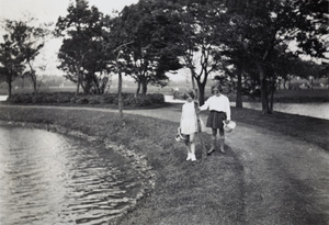 Marjorie Ephgrave and Peggie Clements by a boating pond in a park, Shanghai