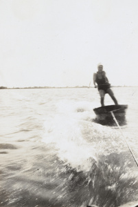 A young woman water-skiing