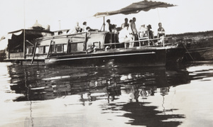 A motorboat beside a houseboat