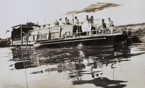 A motorboat beside a houseboat