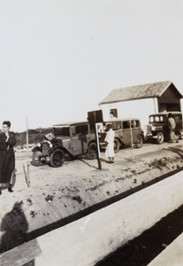 People and cars at a toll bridge