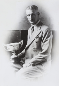 Mr Pulman holding a trophy cup