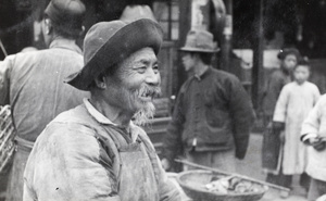 An elderly man in a busy street