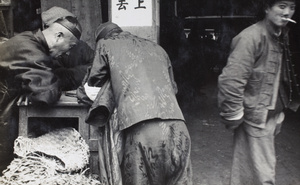 Men wearing silk clothing at a street stall