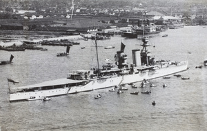 A Royal Navy ship and small boats on the Huangpu river, Shanghai