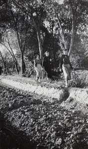 Three women walking on a path by a field near Shanghai Rowing Club