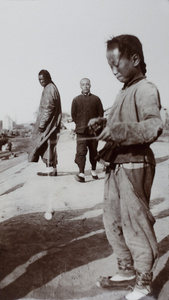 A boy playing with a diabolo (空竹 - Kongzhu - Chinese yo-yo), Tianjin