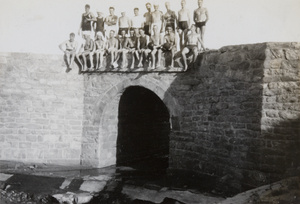Royal Navy sailors, wearing swimsuits, posed above a water gate, Weihai (威海)