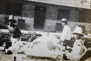 Three workers mixing cement