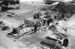 Roadmenders and women stonebreakers working near HMS Tamar, Hong Kong