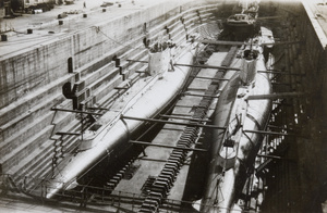 Two submarines and a tug boat, in a dry dock, Hong Kong