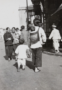 Women and children walking on the street, Hong Kong