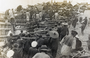 Men carrying the wayward torpedo dubbed the 'Red Herring'