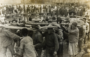 Men carrying the wayward torpedo dubbed the 'Red Herring'