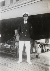 F. Hagger by a boat on a cradle, HMS Medway