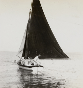 A man swimming near a dinghy, Weihai (威海)