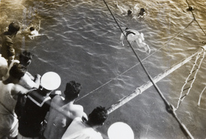 Royal Navy sailors diving and swimming in the sea