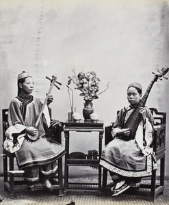 Two musicians (singers), with instruments, near Xingcun